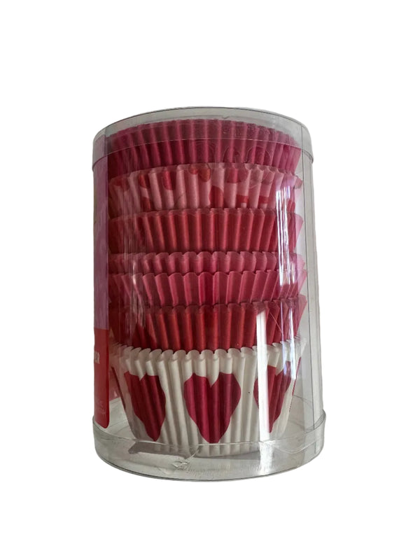 Clear cylindrical container filled with red and white cupcake liners on a light gray background
