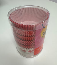 Container of pink cupcake liners on a white surface