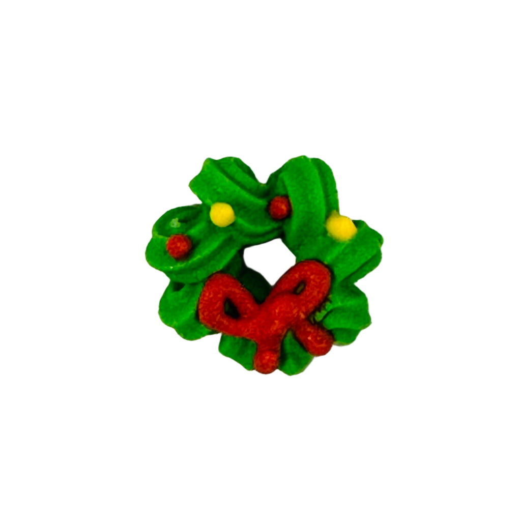 Small royal icing green christmas wreath with red center and yellow berries on a white background