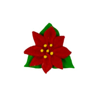 Red poinsettia royal icing flower with green leaves on a white background