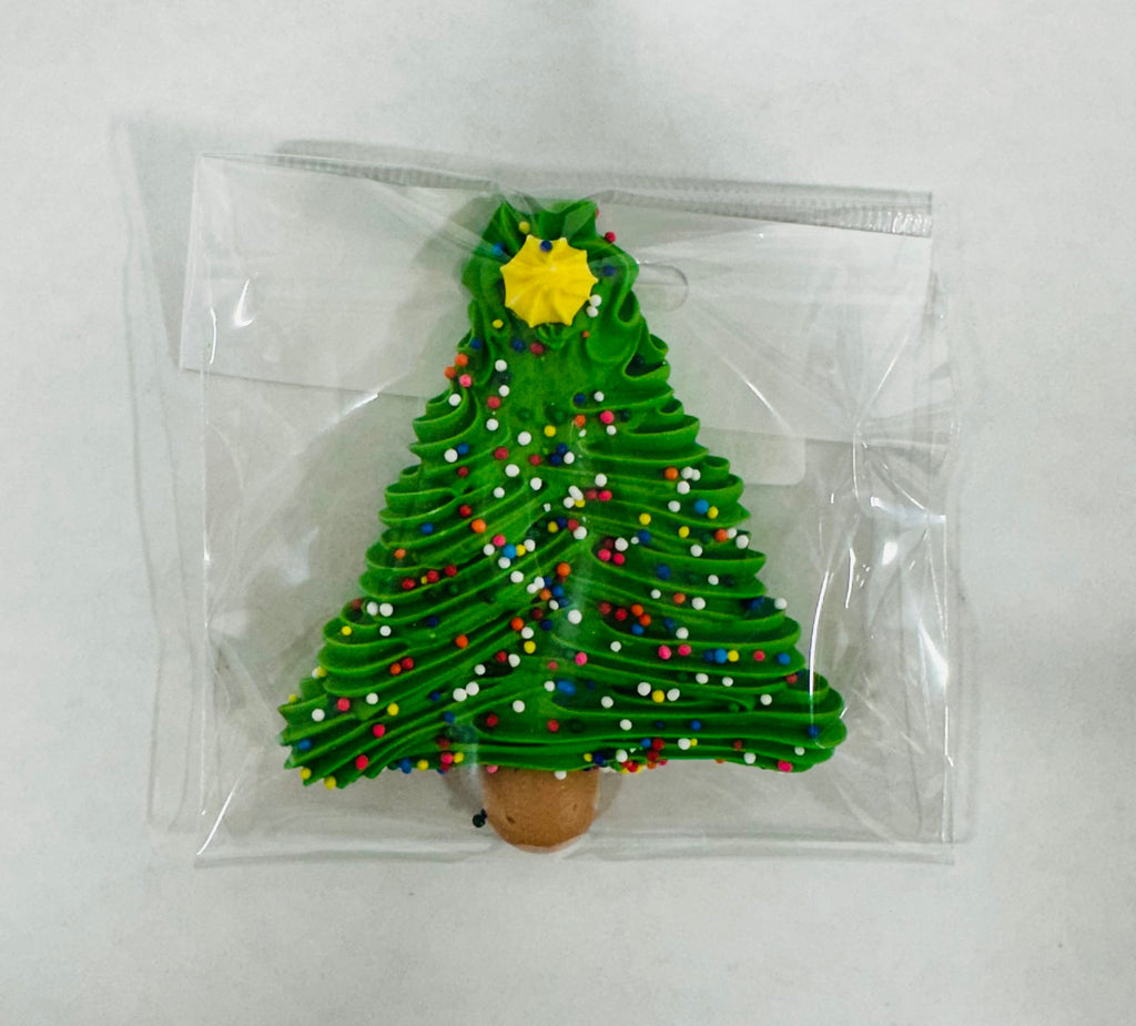 Christmas tree-shaped Sugar Royal Icing in a clear plastic bag on a white background