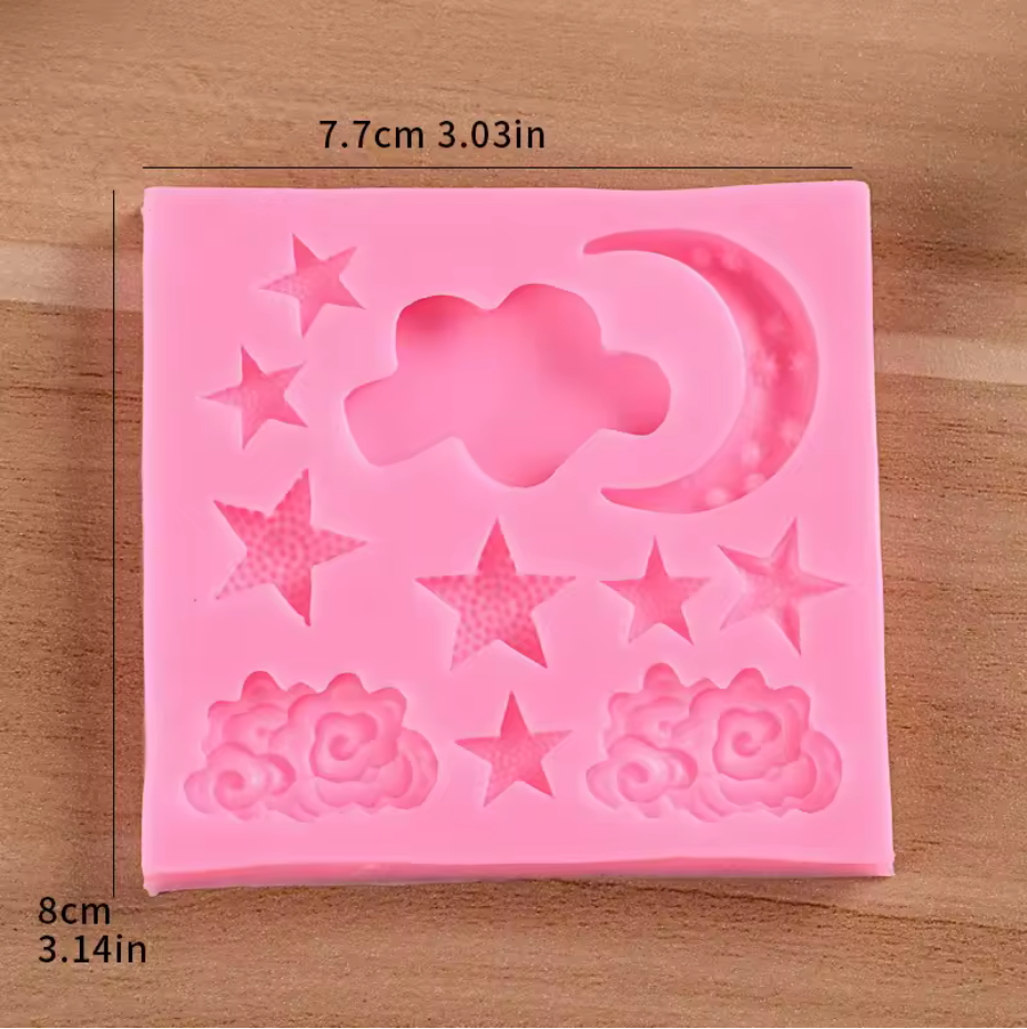 Pink silicone mold with star, cloud, and rose designs on a wooden surface