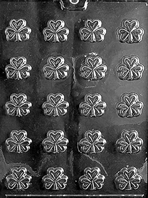 Chocolate mold with clover leaf shapes on a black background