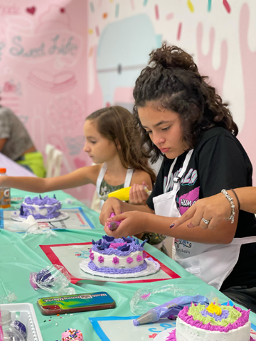 Children decorating colorful cakes with frosting